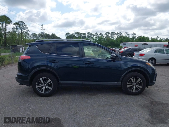 2018 Toyota RAV4 XLE with VIN JTMWFREV9JJ165655, listed as a IAAI auction lot 42138998 with 123,569 mi miles and . Bid and sale history available at carsss.com. Image 13.