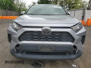 2019 Toyota RAV4 LE with VIN JTMG1RFV4KD004180, listed as a Copart auction lot 57127095 with 71,454 mi miles and Salvage title. Bid and sale history available at DreamBid. Image 5.