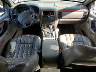 1999 Jeep Grand Cherokee Limited with VIN 1J4GW68S2XC677334, listed as a Copart auction lot 74152054 with 242,220 mi miles and Salvage Title. Bid and sale history available at carsss.com. Image 8.