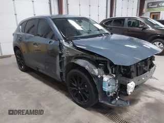 2021 Mazda CX-5 Touring z VIN JM3KFBCM4M0459465, wystawiony jako IAAI lot #41059836 z przebiegiem 74 645 mil mil oraz . Historia ofert i sprzedaży dostępna na DreamBid. Obrazek 1.