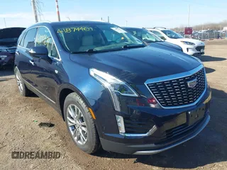 2021 Cadillac XT5 FWD Premium Luxury z VIN 1GYKNCRS2MZ141440, wystawiony jako IAAI lot #41874409 z przebiegiem 76 911 mil mil oraz . Historia ofert i sprzedaży dostępna na DreamBid. Obrazek 1.
