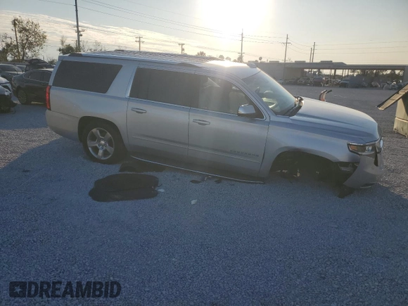 2020 Chevrolet Suburban Premier with VIN 1GNSCJKC9LR198484, listed as a Copart auction lot 87354514 with 115,008 mi miles and Salvage title. Bid and sale history available at DreamBid. Image 4.
