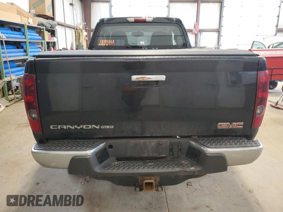 2009 GMC Canyon Work Truck z VIN 1GTDT19E798132510, wystawiony jako Copart lot #57361995 z przebiegiem 240 338 mil mil oraz Czysty tytuł • Clean title. Historia ofert i sprzedaży dostępna na DreamBid. Obrazek 6.
