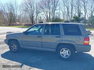 1997 Jeep Grand Cherokee Laredo with VIN 1J4GZ58S7VC713517, listed as a IAAI auction lot 42062214 with 205,533 mi miles. Bid and sale history available at carsss.com. Image 12.