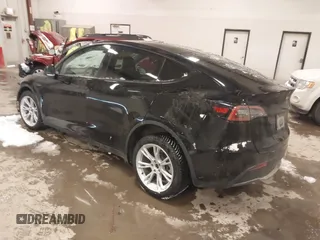 2024 Tesla Model Y Long Range with VIN 7SAYGDEEXRF085795, listed as a IAAI auction lot 41609867 with 57,049 mi miles. Bid and sale history available at carsss.com. Image 3.