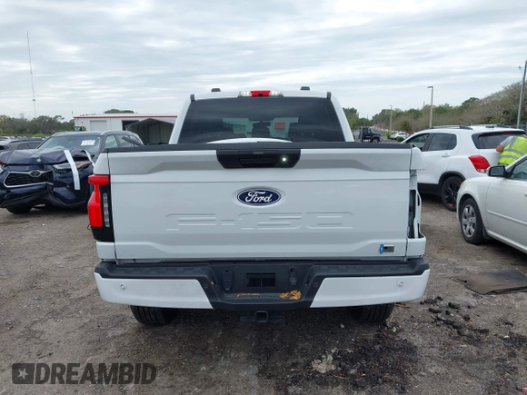 2024 Ford F-150 Lightning XLT with VIN 1FTVW3LKXRWG01185, listed as a IAAI auction lot 41679606 with 4,961 mi miles and . Bid and sale history available at DreamBid. Image 17.