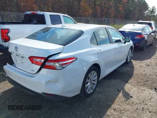 2020 Toyota Camry LE with VIN 4T1C11AKXLU986310, listed as a IAAI auction lot 40977100 with 108,208 mi miles and . Bid and sale history available at DreamBid. Image 4.
