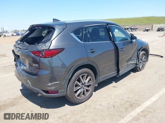 2017 Mazda CX-5 Grand Touring with VIN JM3KFADL6H0217850, listed as a IAAI auction lot 42033404 with 74,198 mi miles and . Bid and sale history available at carsss.com. Image 4.