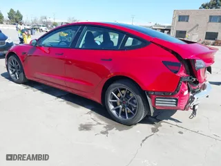 2021 Tesla Model 3 Standard Range Plus with VIN 5YJ3E1EA0MF099562, listed as a IAAI auction lot 41771323 with 26,087 mi miles. Bid and sale history available at carsss.com. Image 3.