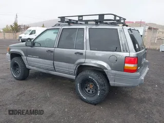 1997 Jeep Grand Cherokee Laredo with VIN 1J4GZ58Y8VC624804, listed as a IAAI auction lot 41736324 with 165,851 mi miles. Bid and sale history available at carsss.com. Image 3.
