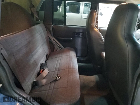 2000 Jeep Cherokee z VIN 1J4FF48S0YL153259, wystawiony jako Copart lot #52509955 z przebiegiem 204 042 mil mil oraz Czysty tytuł • Clean title. Historia ofert i sprzedaży dostępna na DreamBid. Obrazek 11.