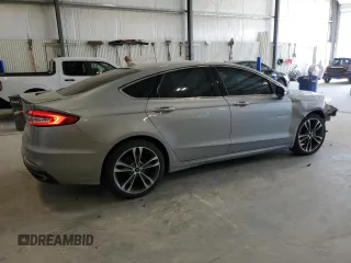 2020 Ford Fusion Titanium с VIN 3FA6P0K90LR112034, выставлен на аукционе Copart как лот 56740025 с пробегом 89 117 миль миль и Списание • Salvage title. История ставок и продаж доступна на DreamBid. Изображение 3.