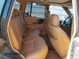 1998 Jeep Grand Cherokee with VIN 1J4FX48S8WC281615, listed as a Copart auction lot 77305594 with 128,393 mi miles and Salvage title. Bid and sale history available at DreamBid. Image 11.