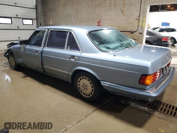 1986 Mercedes-Benz 560 with VIN WDBCA39DXGA213770, listed as a Copart auction lot 49787355 with 218,547 mi miles and Salvage Title. Bid and sale history available at DreamBid. Image 2.