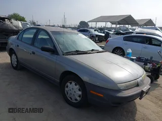 1999 Saturn SL z VIN 1G8ZH5280XZ249494, wystawiony jako IAAI lot #42347493 z przebiegiem 106 491 mil mil oraz . Historia ofert i sprzedaży dostępna na DreamBid. Obrazek 1.