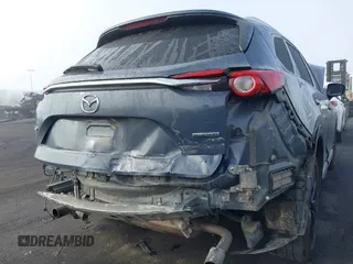 2021 Mazda CX-9 Grand Touring with VIN JM3TCADY1M0519288, listed as a IAAI auction lot 41186094 with 50,701 mi miles and . Bid and sale history available at DreamBid. Image 6.