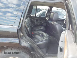 1999 Jeep Grand Cherokee Limited with VIN 1J4GW68NXXC637464, listed as a IAAI auction lot 41561690 with 235,728 mi miles. Bid and sale history available at carsss.com. Image 8.