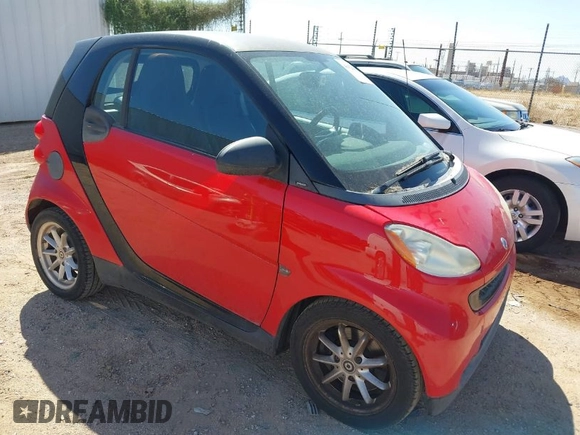 2009 Smart fortwo Pure z VIN WMEEJ31X59K291372, wystawiony jako IAAI lot #41826469 z przebiegiem 87 773 mil mil oraz . Historia ofert i sprzedaży dostępna na DreamBid. Obrazek 1.