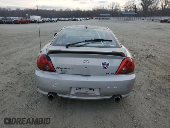 2003 Hyundai Tiburon GT z VIN KMHHN65F63U064962, wystawiony jako Copart lot #44804045 z przebiegiem 186 171 mil mil oraz Szkoda całkowita • Salvage title. Historia ofert i sprzedaży dostępna na DreamBid. Obrazek 6.