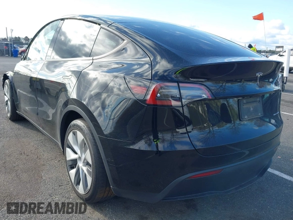 2022 Tesla Model Y Long Range with VIN 7SAYGAEE4NF522330, listed as a IAAI auction lot 42046691 with 59,980 mi miles and . Bid and sale history available at carsss.com. Image 3.