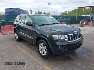 2011 Jeep Grand Cherokee 70th Anniversary with VIN 1J4RR4GG3BC631831, listed as a IAAI auction lot 42038415 with 130,811 mi miles. Bid and sale history available at carsss.com. Image 1.