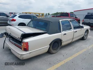 1997 Lincoln Town Car Cartier with VIN 1LNLM83W8VY627663, listed as a IAAI auction lot 42392454 with 209,440 mi miles and . Bid and sale history available at DreamBid. Image 4.