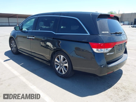 2014 Honda Odyssey Touring with VIN 5FNRL5H99EB133864, listed as a IAAI auction lot 42201359 with 122,490 mi miles and . Bid and sale history available at DreamBid. Image 3.