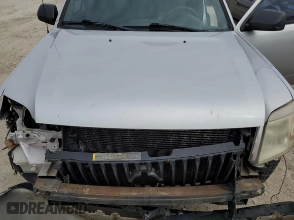 2011 Mercury Mariner z VIN 4M2CN8B73BKJ06886, wystawiony jako Copart lot #50308485 z przebiegiem 118 584 mil mil oraz Szkoda całkowita • Salvage title. Historia ofert i sprzedaży dostępna na DreamBid. Obrazek 13.