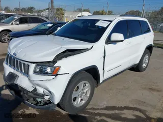 2014 Jeep Grand Cherokee Laredo with VIN 1C4RJEAGXEC130399, listed as a IAAI auction lot 41861664 with 106,925 mi miles. Bid and sale history available at carsss.com. Image 2.