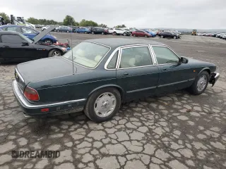 1996 Jaguar XJ with VIN SAJHX1741TC758740, listed as a Copart auction lot 73377914 with 140,964 mi miles and Salvage title. Bid and sale history available at DreamBid. Image 3.