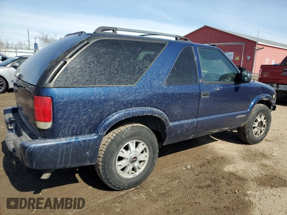 2003 GMC Jimmy z VIN 1GKCT18X43K110056, wystawiony jako Copart lot #48671585 z przebiegiem 272 867 mil mil oraz Czysty tytuł • Clean title. Historia ofert i sprzedaży dostępna na DreamBid. Obrazek 3.