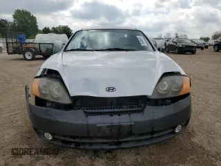 2003 Hyundai Tiburon z VIN KMHHM65D43U017995, wystawiony jako Copart lot #56498665 z przebiegiem 162 820 mil mil oraz Szkoda całkowita • Salvage title. Historia ofert i sprzedaży dostępna na DreamBid. Obrazek 5.