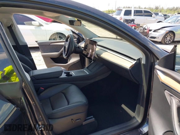 2024 Tesla Model Y with VIN 7SAYGDED3RF019063, listed as a IAAI auction lot 42061888 with 13,763 mi miles and . Bid and sale history available at DreamBid. Image 5.