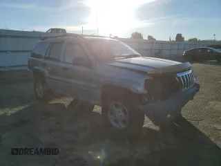 1999 Jeep Grand Cherokee Laredo with VIN 1J4GW58NXXC747537, listed as a Copart auction lot 87310234 with Not provided miles and Salvage title. Bid and sale history available at DreamBid. Image 4.