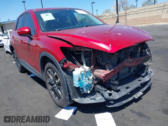 2016 Mazda CX-5 Grand Touring z VIN JM3KE2DY2G0660385, wystawiony jako IAAI lot #42101004 z przebiegiem 166 336 mil mil oraz . Historia ofert i sprzedaży dostępna na DreamBid. Obrazek 1.
