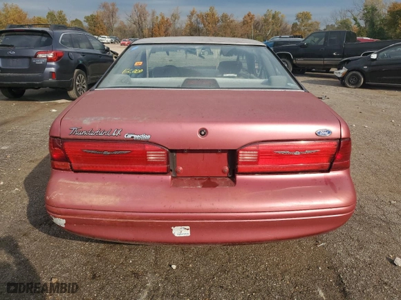 1996 Ford Thunderbird LX with VIN 1FALP62W7TH135632, listed as a Copart auction lot 77134024 with 128,931 mi miles and Salvage Title. Bid and sale history available at carsss.com. Image 6.