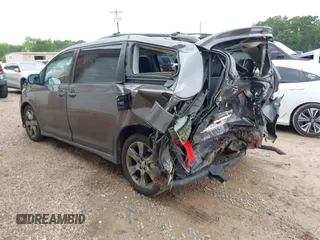 2012 Toyota Sienna SE with VIN 5TDXK3DC2CS235211, listed as a IAAI auction lot 42390354 with 242,602 mi miles and . Bid and sale history available at DreamBid. Image 3.