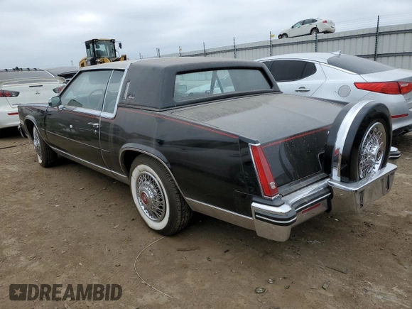 1985 Cadillac Eldorado z VIN 1G6EL5782FE634074, wystawiony jako Copart lot #44520964 z przebiegiem 74 425 mil mil oraz Szkody całkowita. Historia ofert i sprzedaży dostępna na DreamBid. Obrazek 2.