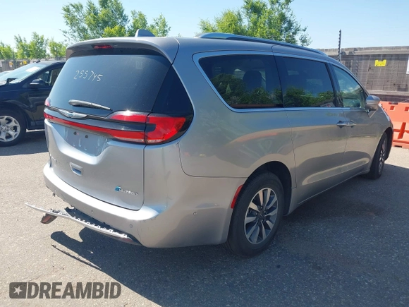 2021 Chrysler Pacifica Hybrid Touring L with VIN 2C4RC1L76MR594571, listed as a IAAI auction lot 40255745 with 58,163 mi miles and . Bid and sale history available at DreamBid. Image 4.