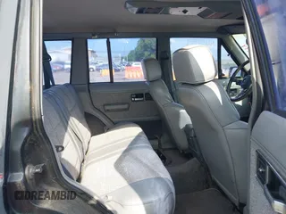 1991 Jeep Cherokee z VIN 1J4FJ58S6ML572036, wystawiony jako IAAI lot #42659999 z przebiegiem 200 845 mil mil oraz . Historia ofert i sprzedaży dostępna na DreamBid. Obrazek 8.