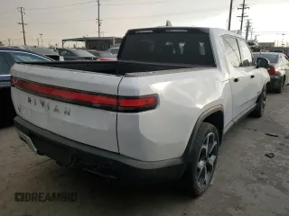 2022 Rivian R1T Adventure z VIN 7FCTGAAA9NN014280, wystawiony jako Copart lot #87908175 z przebiegiem 28 601 mil mil oraz Szkody całkowita. Historia ofert i sprzedaży dostępna na DreamBid. Obrazek 3.
