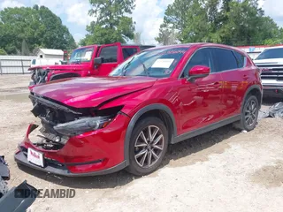2018 Mazda CX-5 Grand Touring with VIN JM3KFADM4J0335913, listed as a IAAI auction lot 42326044 with 104,583 mi miles and . Bid and sale history available at DreamBid. Image 2.