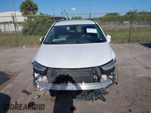 2022 Chrysler Pacifica Touring L with VIN 2C4RC1BGXNR233654, listed as a IAAI auction lot 42137632 with 73,899 mi miles and . Bid and sale history available at DreamBid. Image 12.