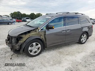 2011 Honda Odyssey Touring with VIN 5FNRL5H94BB072631, listed as a Copart auction lot 62549865 with 215,667 mi miles and Salvage title. Bid and sale history available at DreamBid. Image 1.