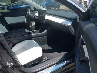 2020 Tesla Model 3 Standard Range Plus with VIN 5YJ3E1EAXLF615781, listed as a IAAI auction lot 42068935 with 96,026 mi miles. Bid and sale history available at carsss.com. Image 5.