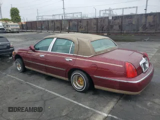 1999 Lincoln Town Car Signature with VIN 1LNHM82W7XY612906, listed as a Copart auction lot 50777435 with 110,414 mi miles and Salvage title. Bid and sale history available at DreamBid. Image 2.