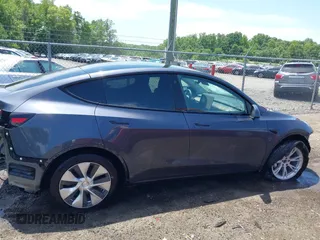 2023 Tesla Model Y Long Range with VIN 7SAYGAEE7PF615751, listed as a IAAI auction lot 42297819 with 31,201 mi miles and . Bid and sale history available at DreamBid. Image 14.