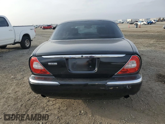 2004 Jaguar XJ with VIN SAJEA71C54SG01455, listed as a Copart auction lot 86591014 with 83,977 mi miles and Salvage Title. Bid and sale history available at carsss.com. Image 6.