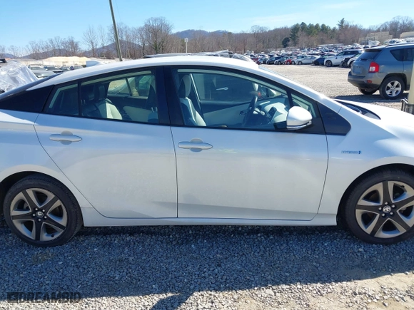 2021 Toyota Prius L Eco with VIN JTDKAMFUXM3142402, listed as a IAAI auction lot 41665484 with 67,416 mi miles. Bid and sale history available at carsss.com. Image 13.