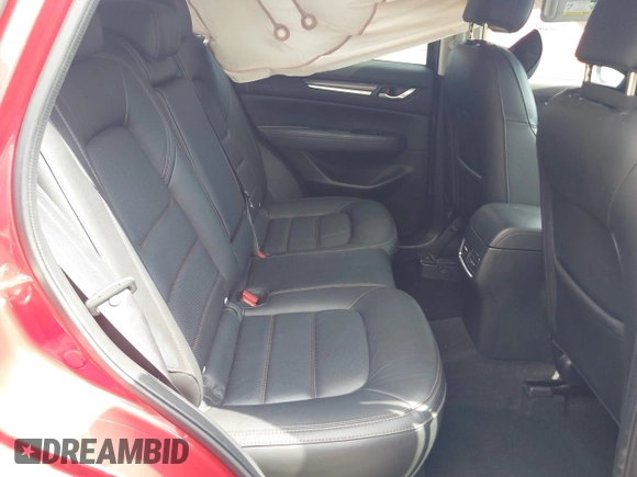 2021 Mazda CX-5 Grand Touring with VIN JM3KFADM6M1373111, listed as a IAAI auction lot 42784431 with 14,374 mi miles and . Bid and sale history available at DreamBid. Image 8.